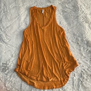 Flowy, burnt yellow/almost orange tank top. Slightly longer in the back!